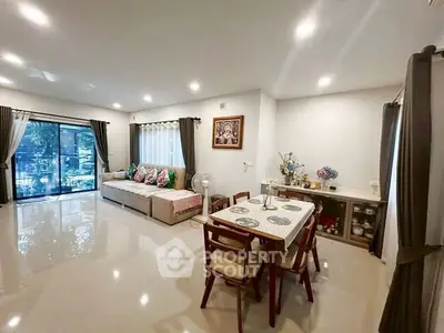 Spacious living room with elegant dining area and large windows