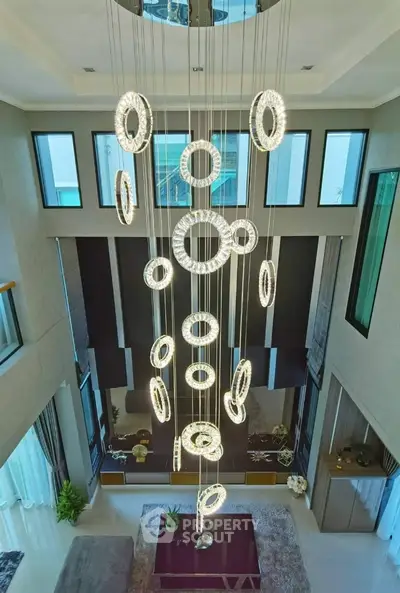 Luxurious modern living room with stunning chandelier and high ceilings