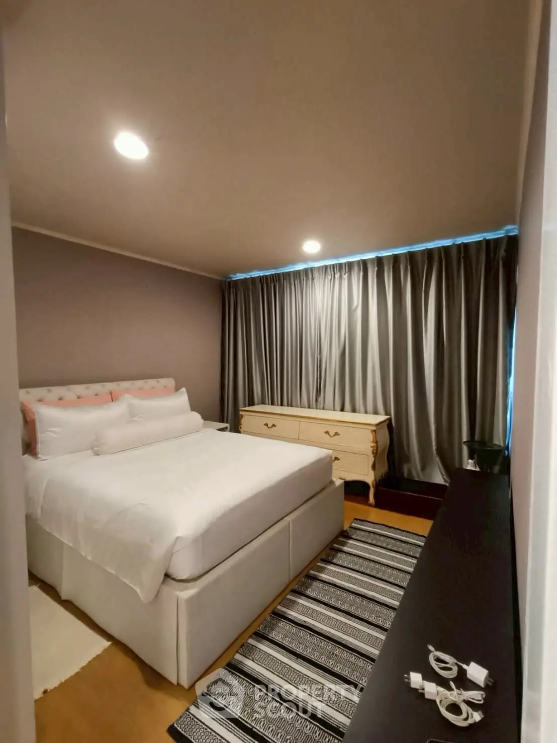 Cozy bedroom with elegant decor and ample natural light