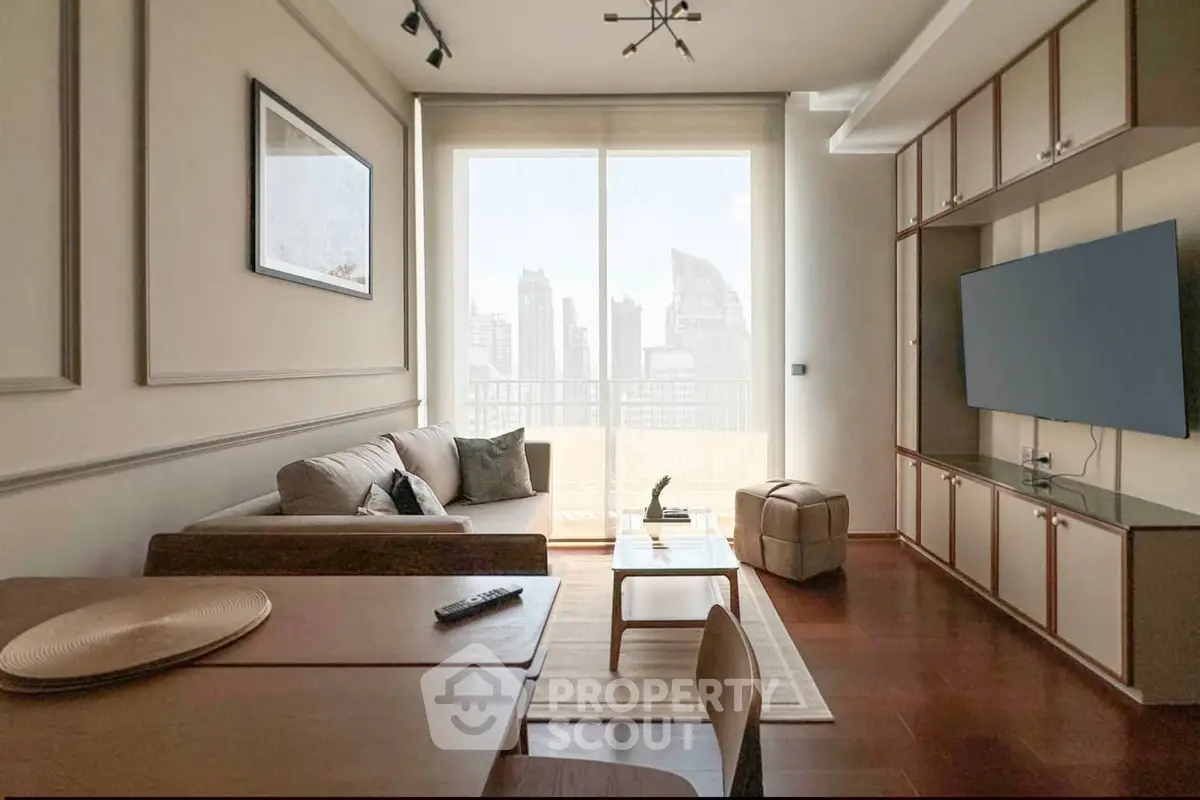 Modern living room with city view, stylish furniture, and large TV, perfect for urban living.