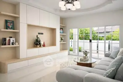 Modern living room with elegant decor and large windows opening to a garden view.