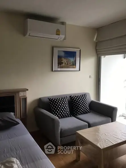 Cozy living room with air conditioning and stylish sofa, perfect for relaxation.