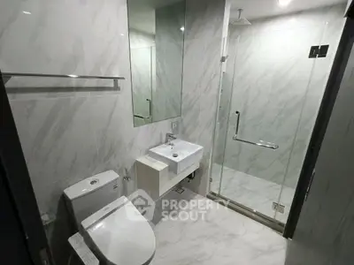 Modern bathroom with sleek design, glass shower, and elegant fixtures in a contemporary home.