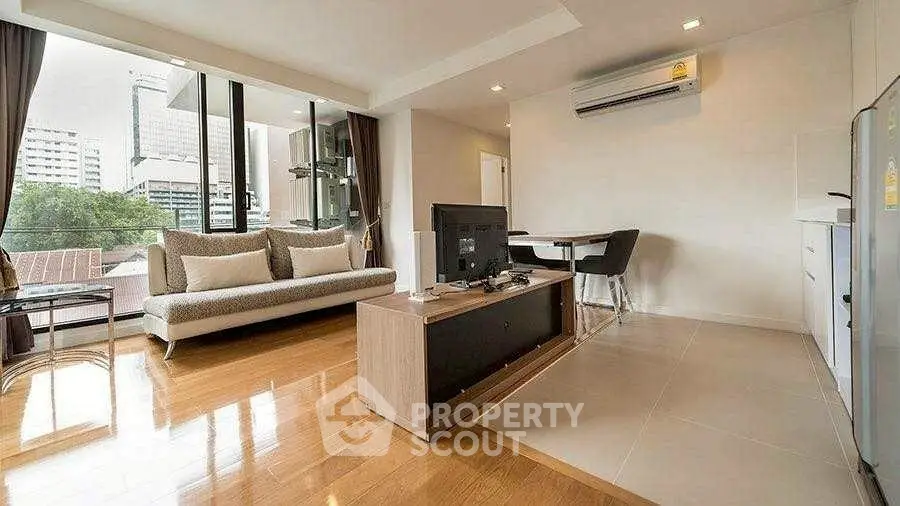 Spacious modern living room with city view and elegant furnishings.