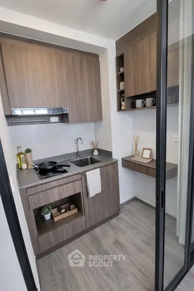 Modern compact kitchen with sleek wooden cabinets and open shelving