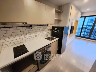 Modern kitchen with sleek appliances and open layout in urban apartment