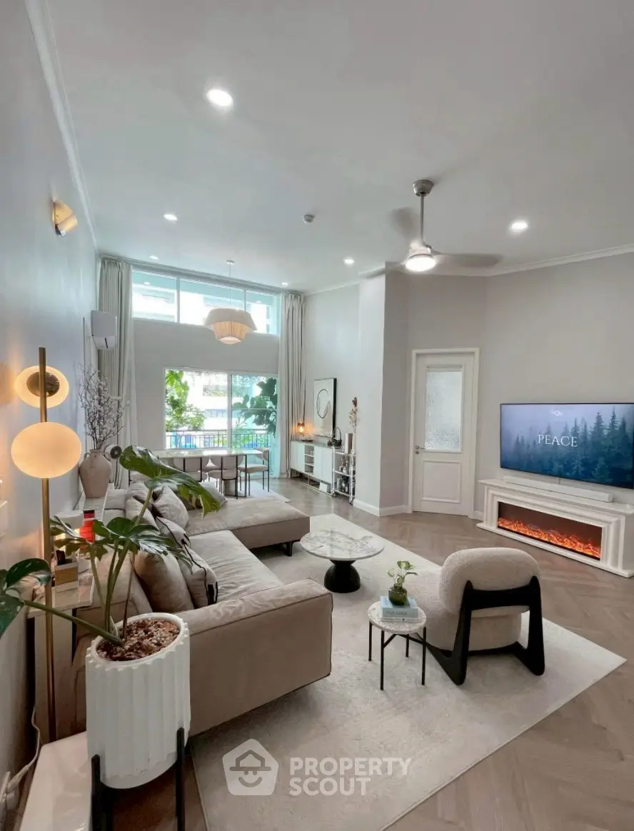 Spacious modern living room with elegant decor and large windows for natural light.