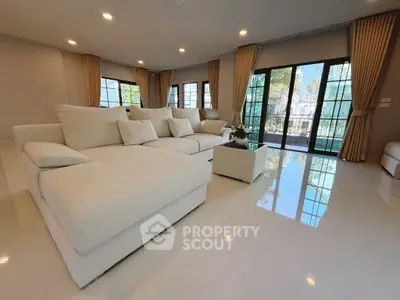 Spacious modern living room with large windows and elegant decor