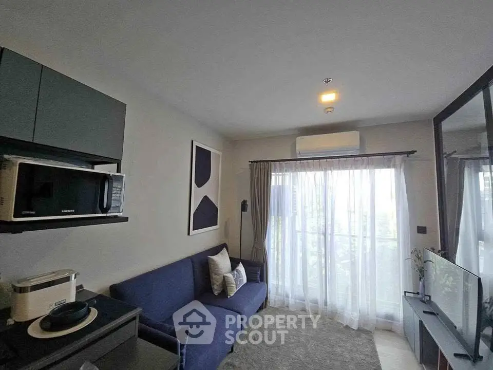 Modern living room with sleek furniture and natural light, featuring a cozy sofa and stylish decor.