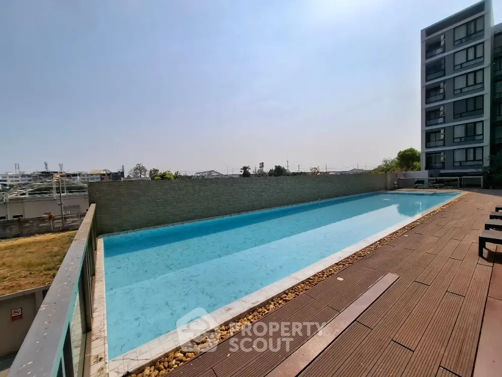 Luxurious rooftop pool with city view in modern apartment complex