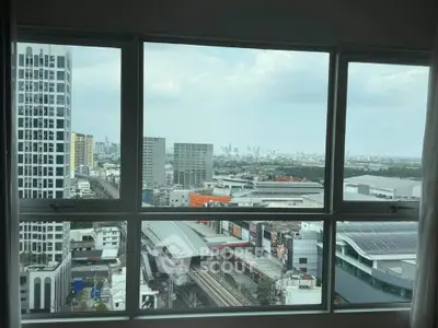 Stunning cityscape view from high-rise apartment window, showcasing urban skyline and modern architecture.
