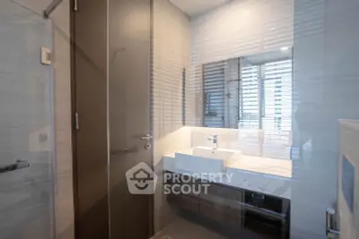Modern bathroom with sleek design and large mirror in luxury apartment