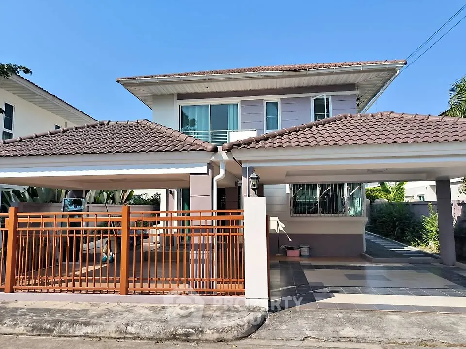 Charming two-story house with tiled roof and spacious driveway in a serene neighborhood.