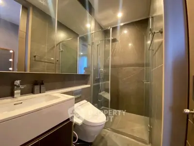 Modern bathroom with glass shower and sleek fixtures