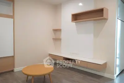 Modern minimalist living room with sleek wooden furniture and neutral tones.