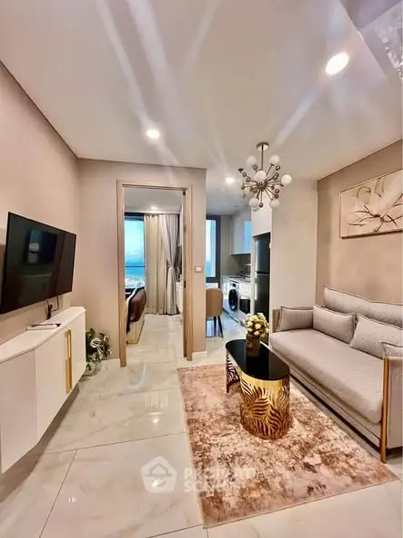 Modern living room with elegant decor and open kitchen layout in a stylish apartment.