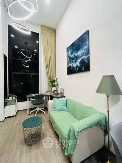 Modern living room with high ceiling, stylish lighting, and cozy decor in a contemporary apartment.