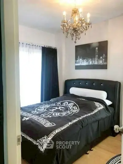 Elegant bedroom with chandelier and stylish decor in modern apartment