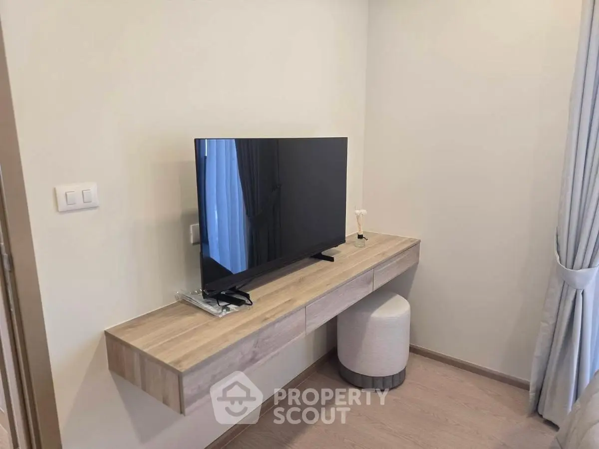 Modern minimalist living room with sleek TV and stylish wooden console