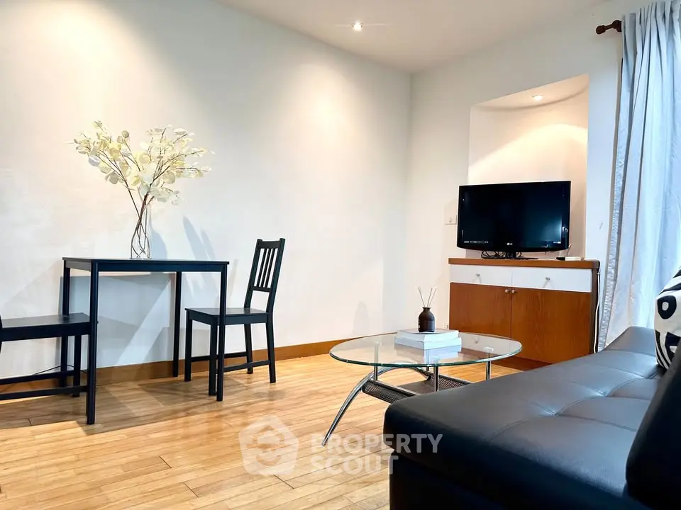 Modern living room with sleek furniture and natural light, perfect for relaxation and entertainment.
