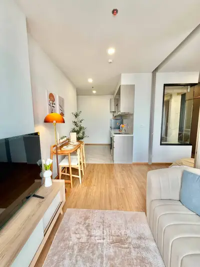 Modern open-plan living room with cozy seating and stylish kitchen area