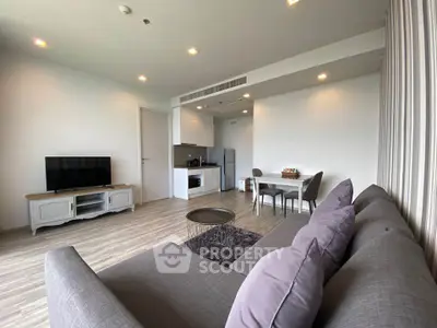 Modern living room with open kitchen and stylish decor