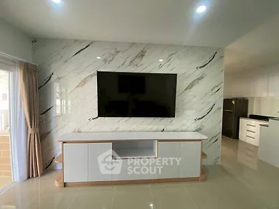 Modern living room with marble accent wall and sleek TV setup