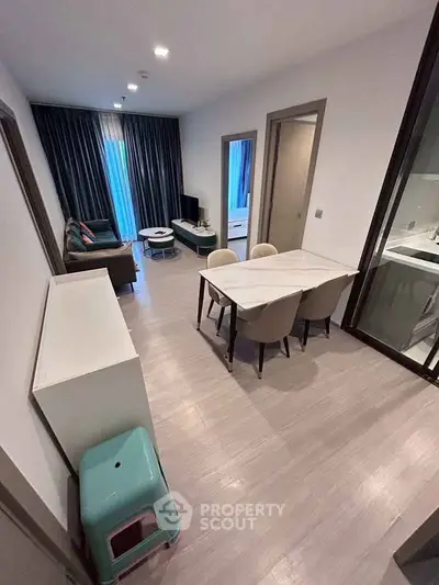 Modern open-plan living and dining area with stylish furniture and natural light.