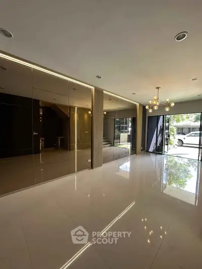 Spacious modern living room with glossy tiles and elegant lighting