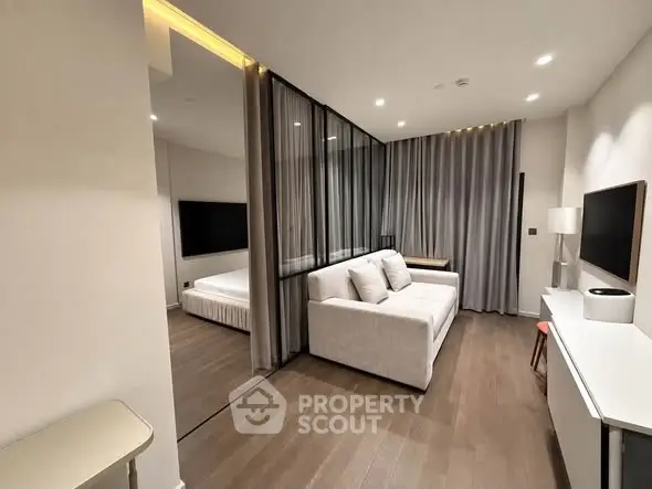 Modern living room with sleek design and cozy ambiance, featuring a stylish sofa and elegant decor.
