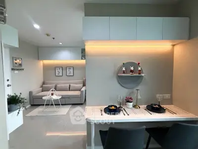 Modern open-plan living room and dining area with stylish decor and ambient lighting.