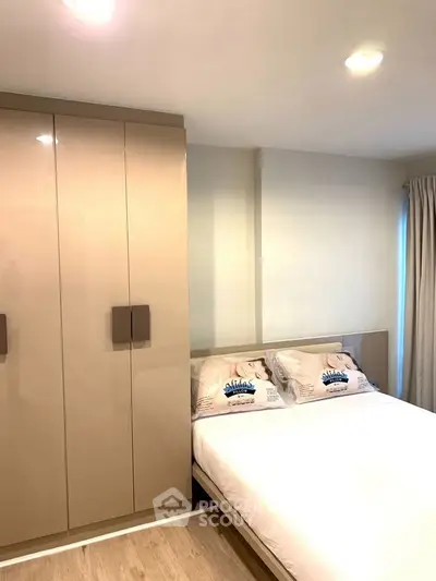 Modern bedroom with sleek wardrobe and cozy bed in stylish apartment.