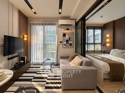 Modern living room with stylish decor and cozy bedroom in open layout apartment