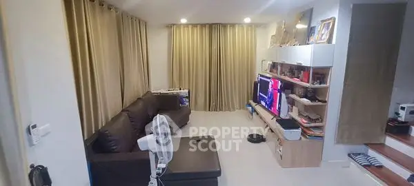 Spacious living room with modern decor and entertainment center