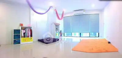 Spacious and bright children's playroom with modern decor and large windows.