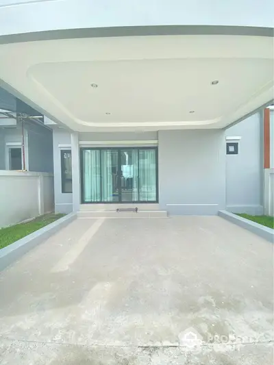 Modern house entrance with sleek design and spacious driveway