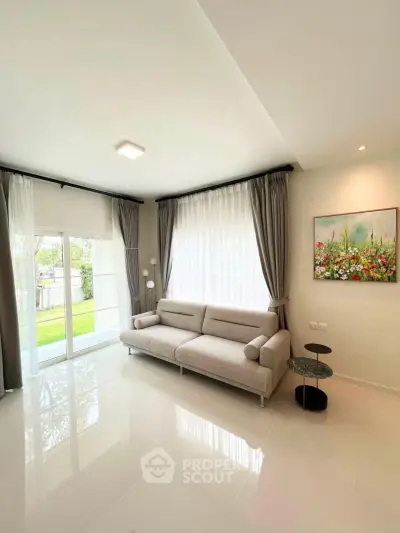 Bright and modern living room with large windows and stylish decor