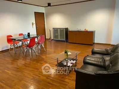 Spacious living room with wooden flooring, modern furniture, and stylish decor