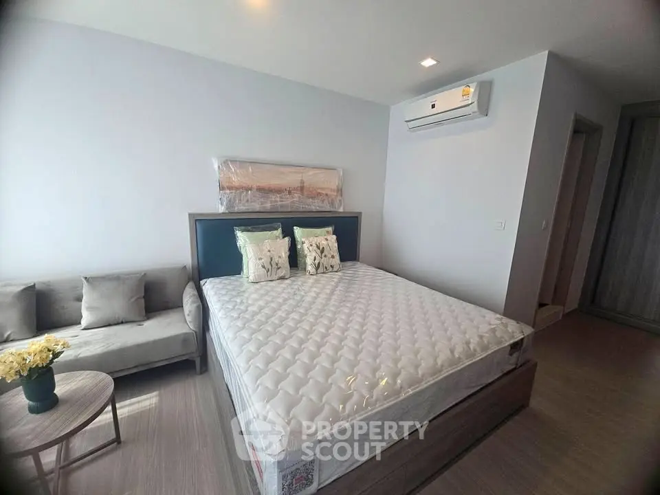 Modern bedroom with air conditioning and stylish decor in a contemporary apartment.