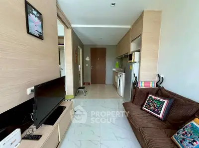 Modern living room with sleek furniture and integrated kitchen appliances