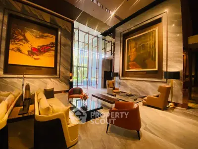 Luxurious modern living room with elegant decor and large artwork, featuring plush seating and natural light.