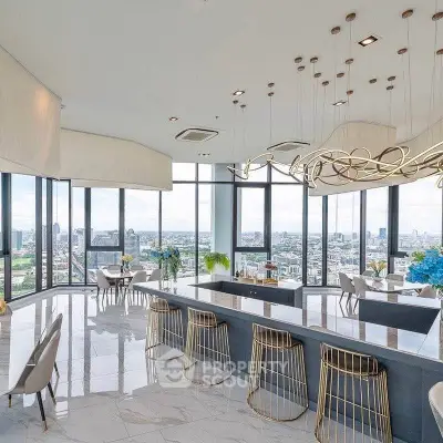 Luxurious modern kitchen with panoramic city views and elegant lighting fixtures.