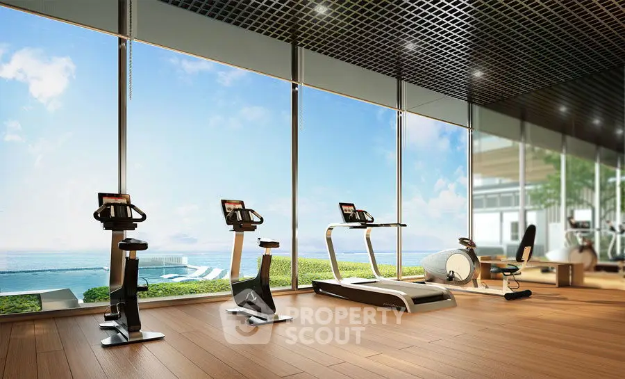 Luxurious gym with ocean view and modern fitness equipment.