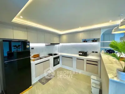 Modern kitchen with sleek cabinetry, marble countertops, and built-in appliances in a contemporary home.