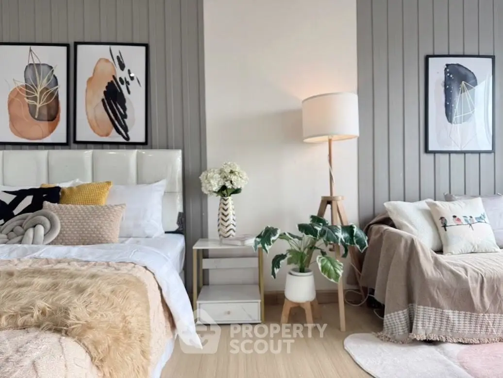 Chic bedroom with modern decor, cozy bedding, and stylish artwork.