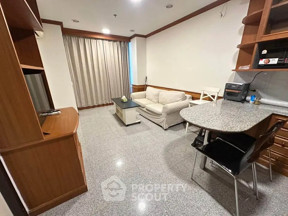 Cozy living room with modern furniture and open kitchen layout, perfect for urban living.