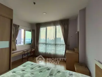 Spacious bedroom with large windows and elegant curtains in modern apartment