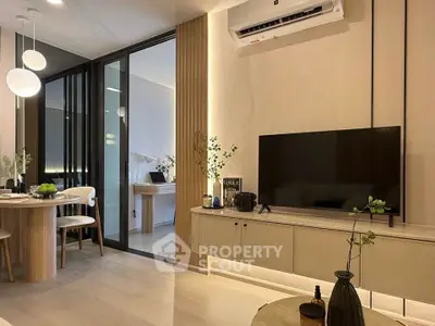 Modern living room with sleek TV unit and dining area, featuring stylish lighting and contemporary decor.