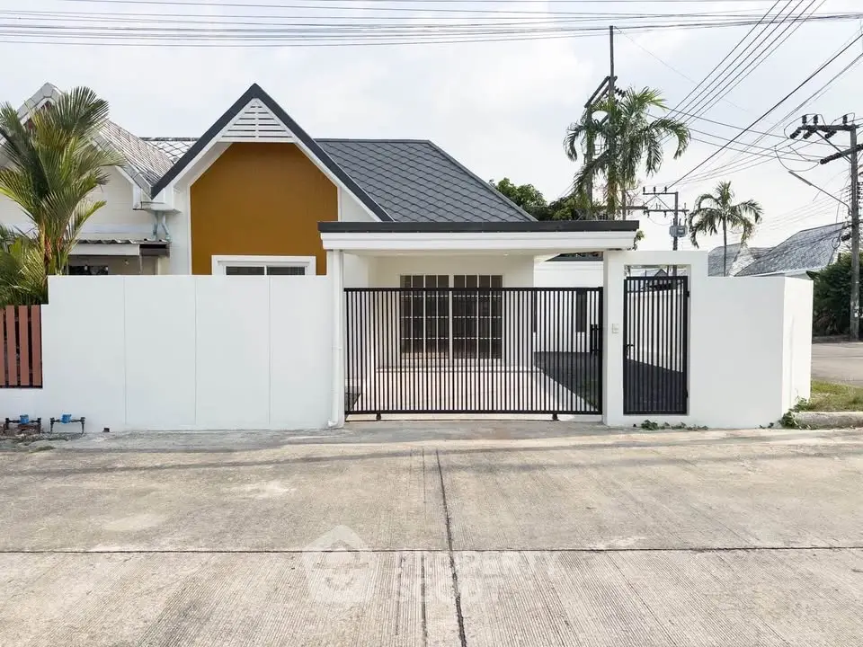 Charming modern house with gated entrance and sleek design in a serene neighborhood.