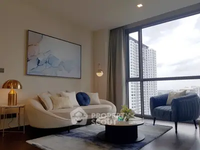 Modern living room with stylish furniture and large window offering city view